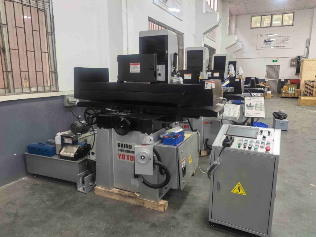 Surface grinder machine working on metal surface finishing