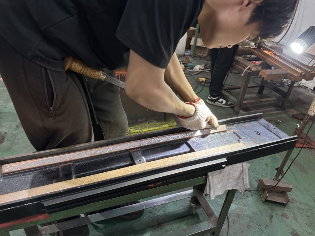 Manual hand scraping on 618 surface grinding machine worktable at YUTON
