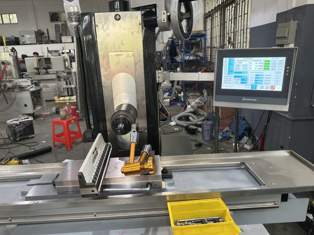 Close-up view of a CNC surface grinder spindle used in the automotive industry for high-volume production.