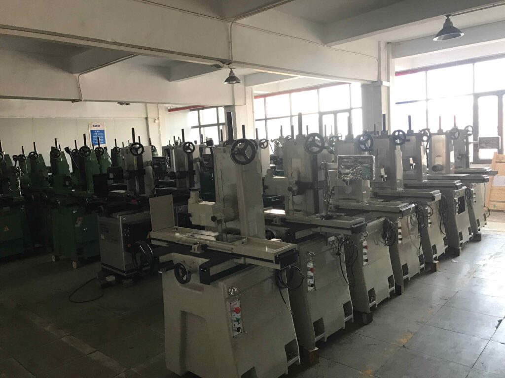 one operator multiple surface grinding machines in factory workshop