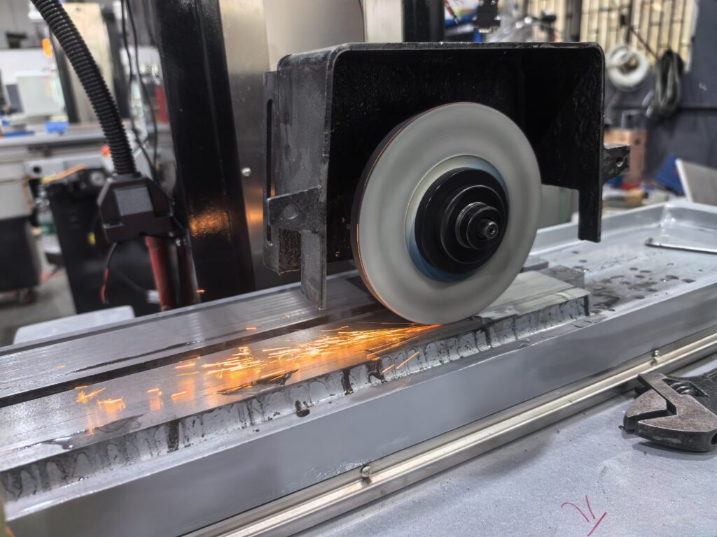 CNC surface grinding machine sparks during metal processing