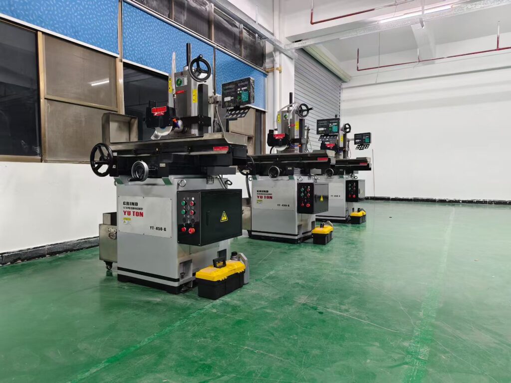 Row of YUTON YT-series CNC surface grinders in a customer production workshop, demonstrating one-operator-multiple-machines workflow for automated grinding process in modern machine shops.