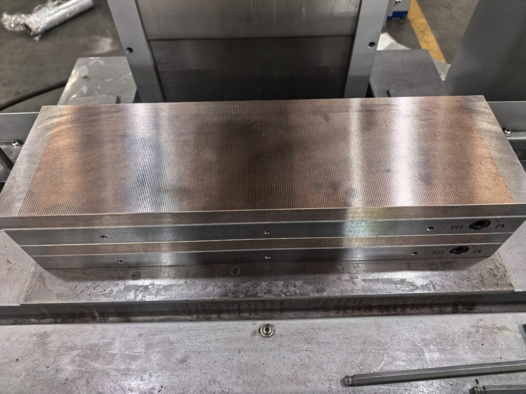 Extreme close-up of a precision-ground aerospace component showing superior surface finish after machining on a surface grinder.