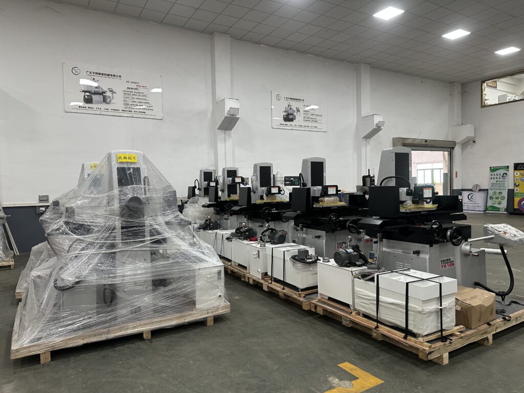Row of YUTON automatic surface grinders in showroom ready for export shipment – precision grinding machines prepared for delivery