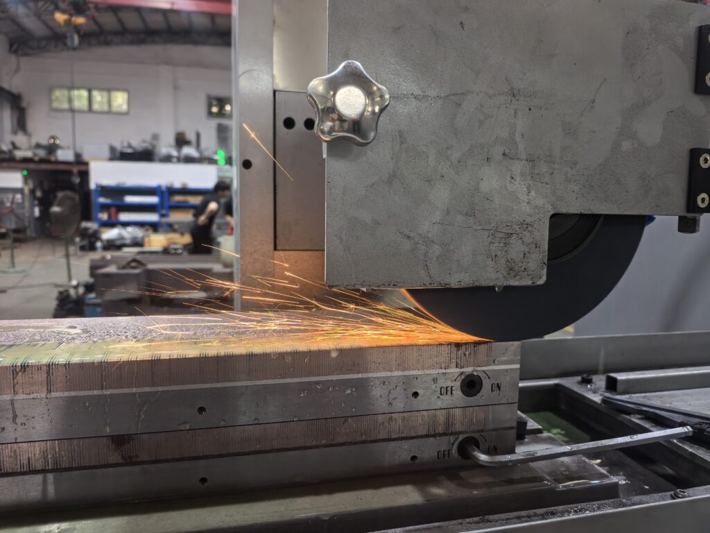 Surface grinder machining a brake disc for automotive parts manufacturing in a precision workshop.