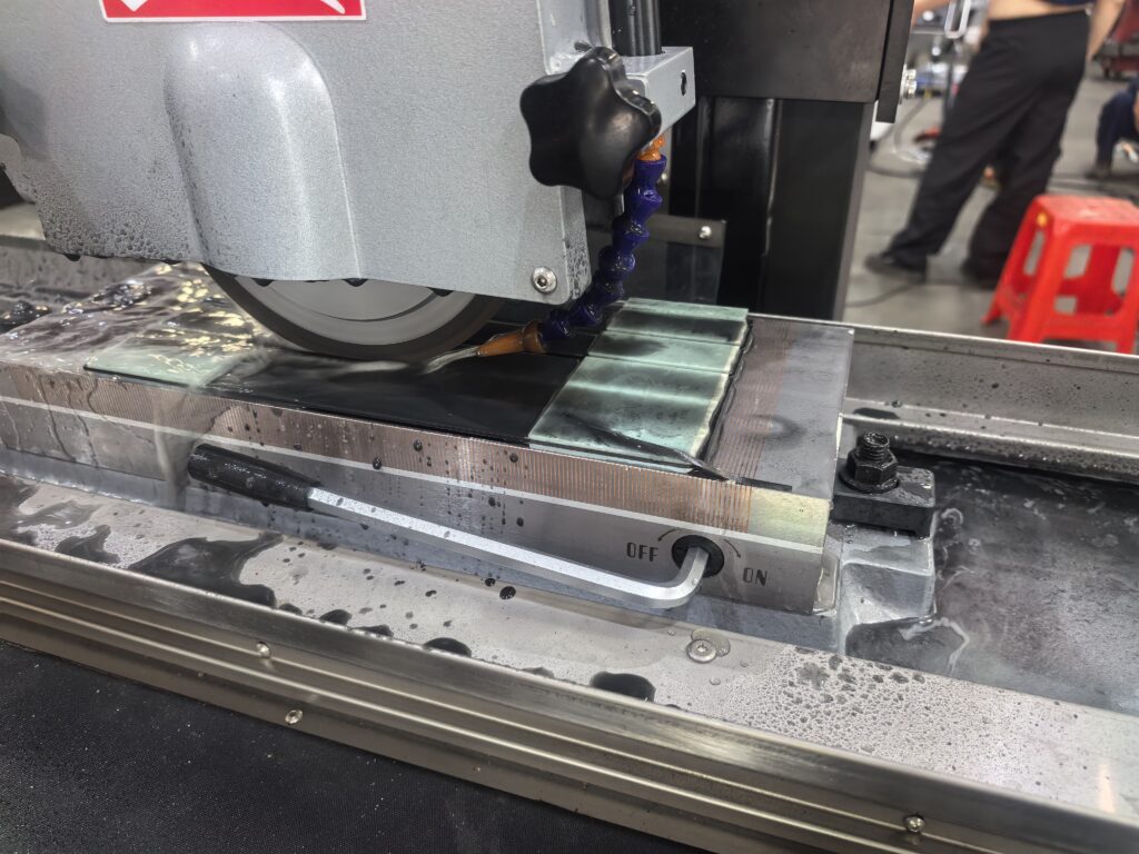 Diamond surface grinding wheel cutting carbon fiber composite (CFRP) sheet on a YUTON grinder, demonstrating abrasive selection for advanced materials in the 2026 wheel types guide.
