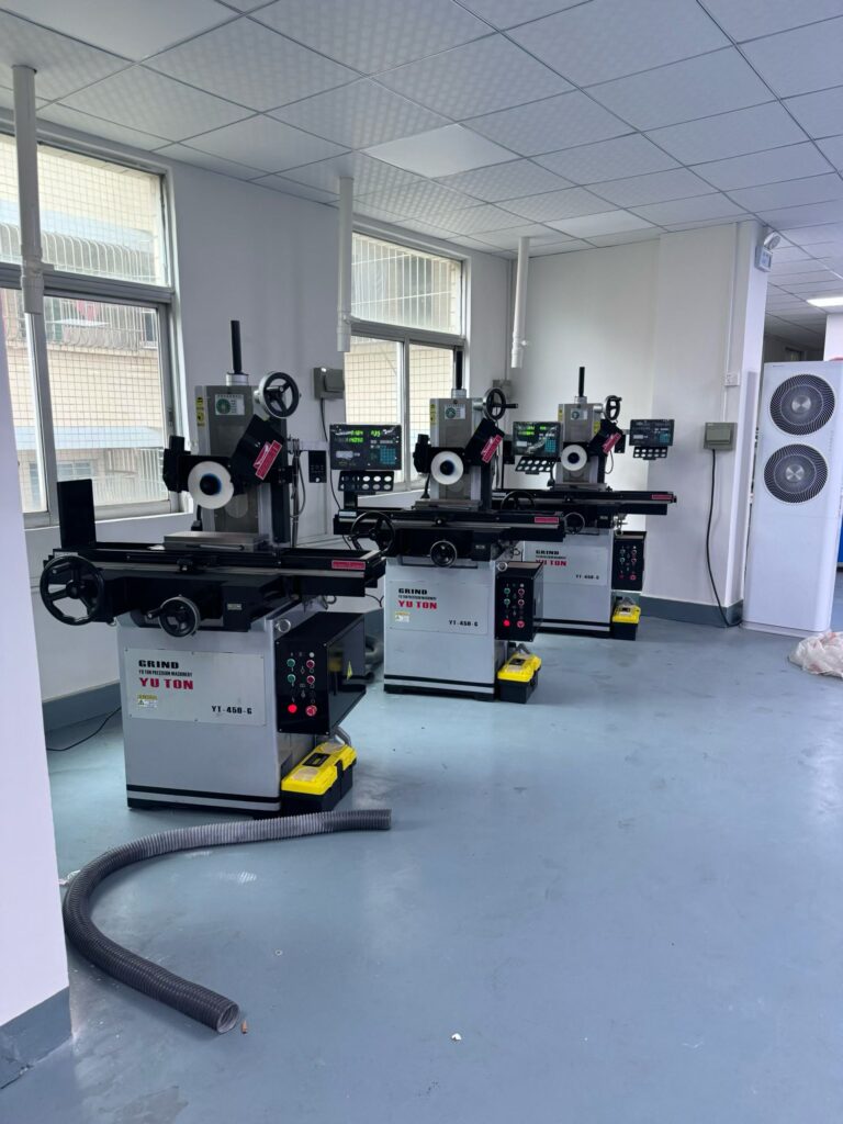 YUTON precision grinder fully installed on factory floor in Southeast Asia, showcasing operational setup with coolant system and control panel.