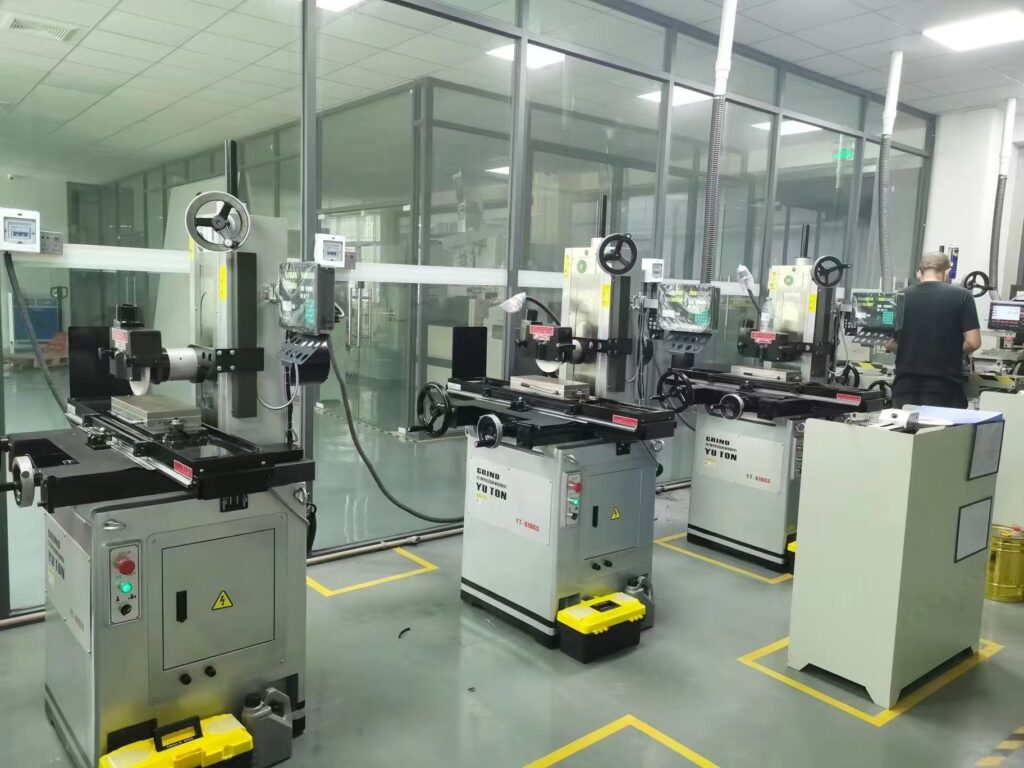 Row of YUTON high-precision surface grinders deployed in a customer's aerospace component manufacturing facility.