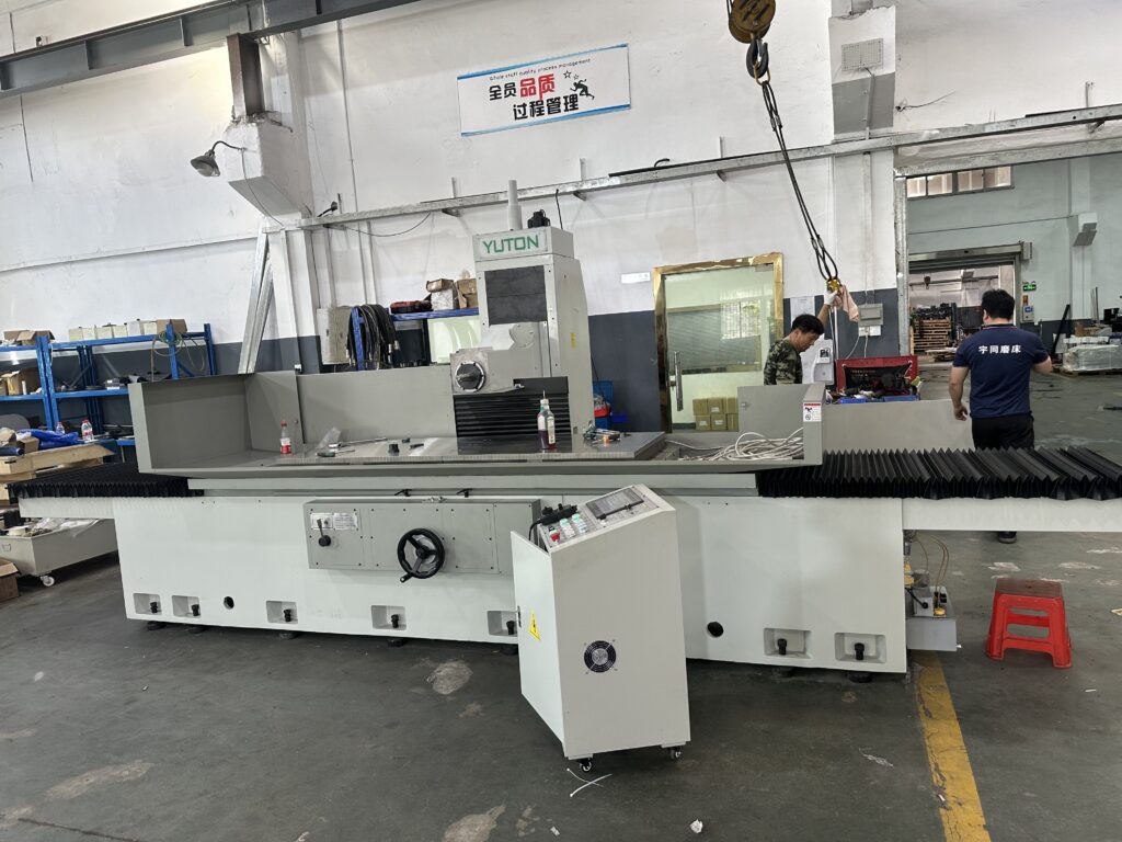 Engineers installing a grinding machine for an overseas manufacturing customer