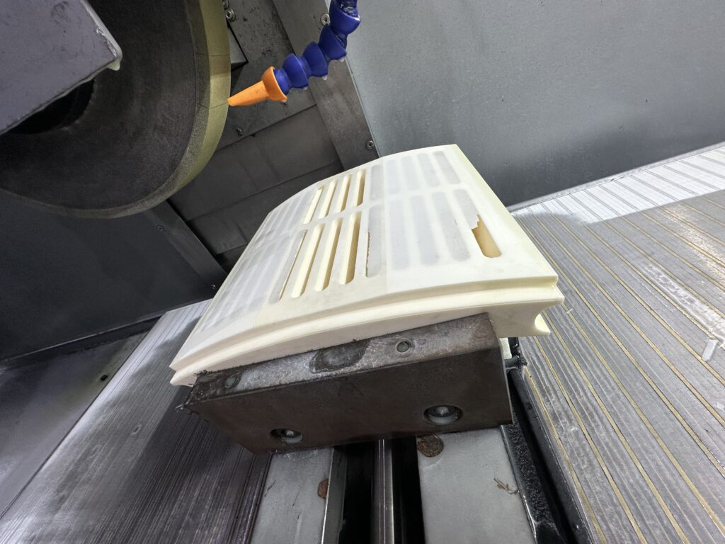 An industrial grinding machine equipped with monitoring sensors that measure grinding force, vibration, temperature, and wheel wear to support adaptive control and improve machining consistency.