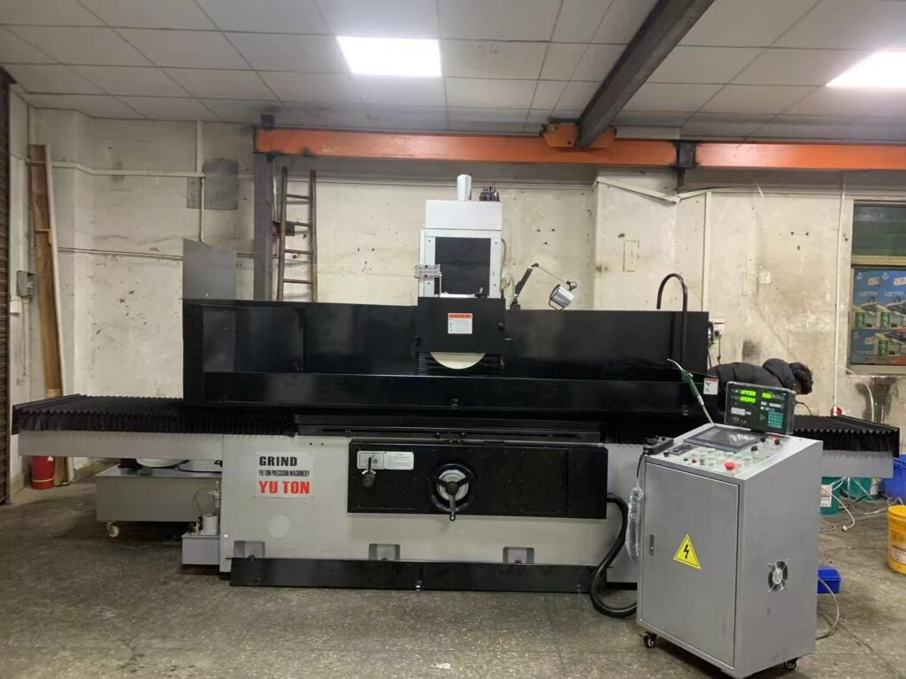 CNC vs manual surface grinder comparison showing two precision grinding machines in the same workshop