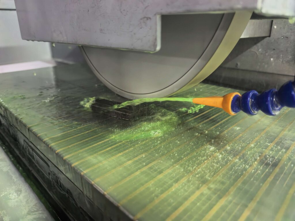 Surface grinder coolant guide showing coolant applied during precision surface grinding