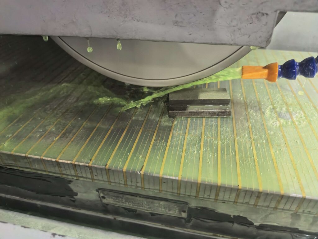 Surface grinding for stainless steel with optimized coolant application during machining