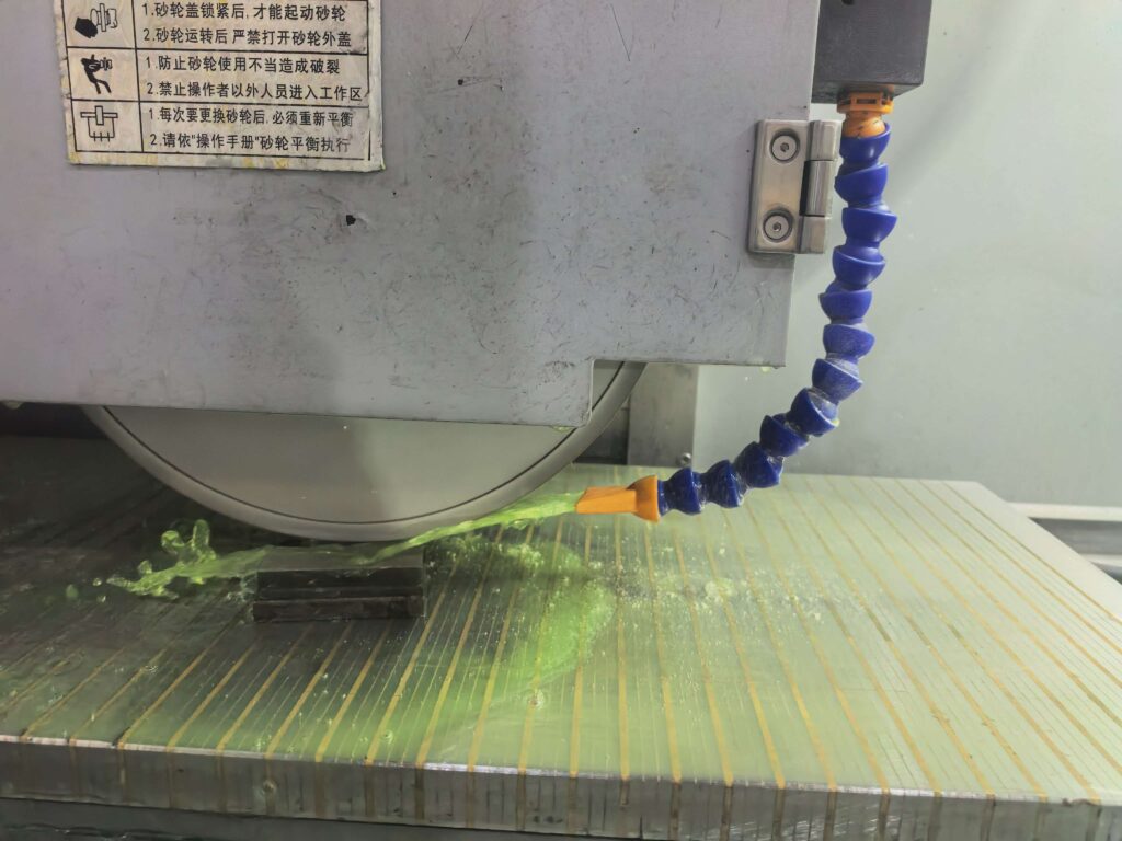 Surface grinding for hardened steel with optimized coolant delivery during machining