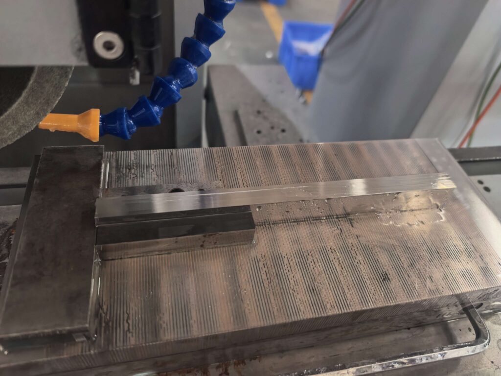 Surface grinder workholding in a precision manufacturing workshop using a magnetic chuck