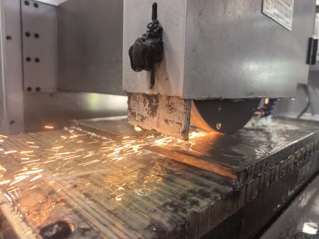 Surface grinder magnetic chuck holding a steel workpiece during precision grinding
