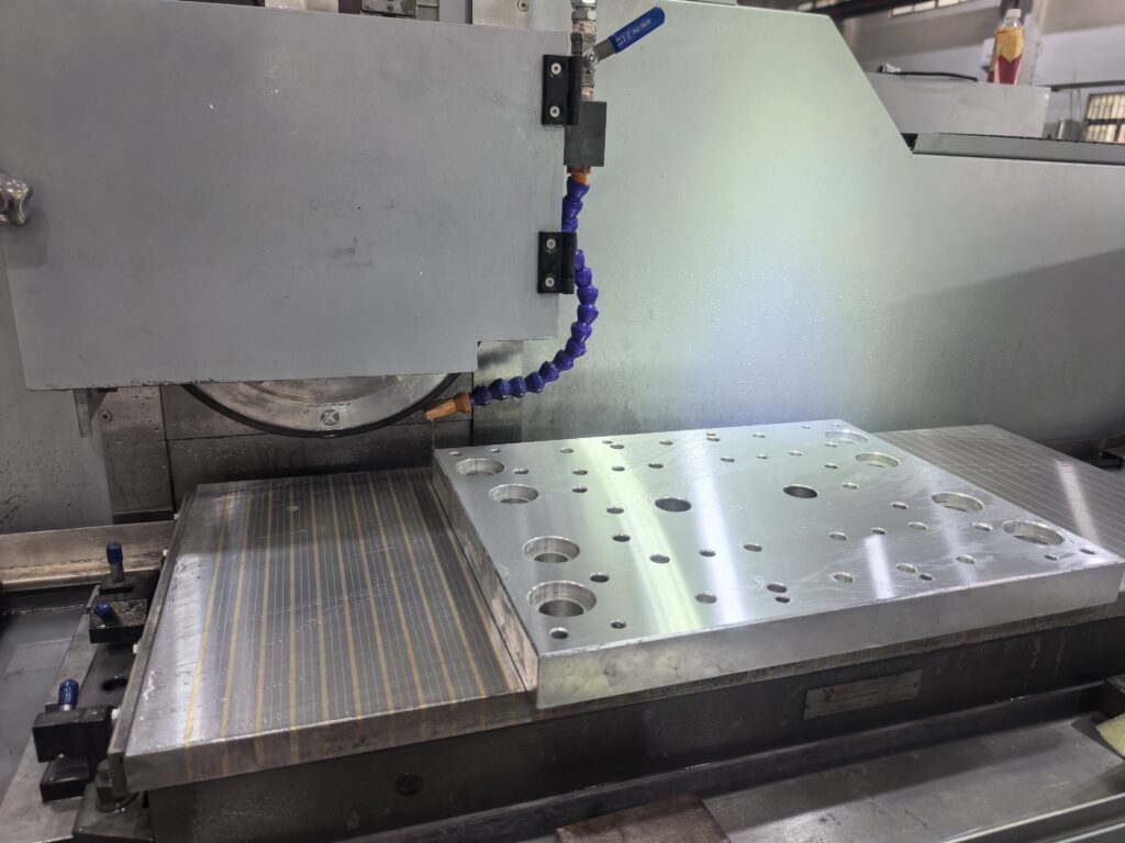 Surface grinder machining hydraulic components for construction machinery