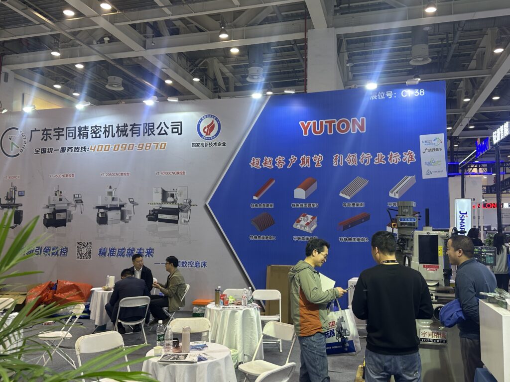 Machine tool distributor demonstrating a surface grinder to an industrial customer